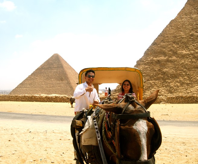 aboard the carriage with the pyramids as background