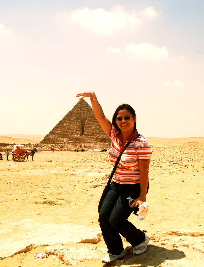 touching the tip of the pyramid