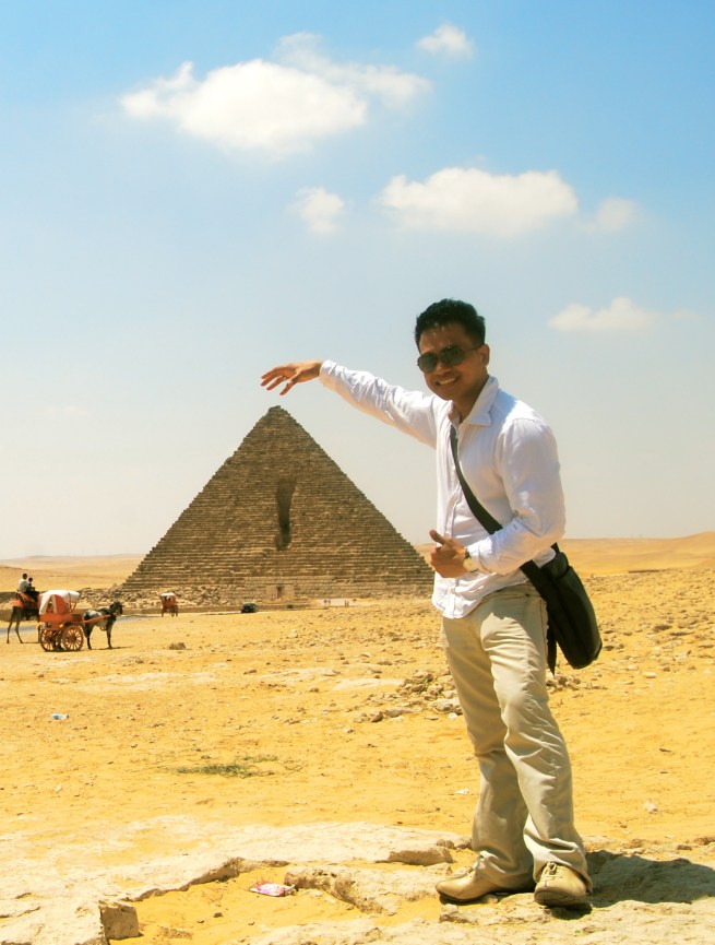 touching the tip of the pyramid